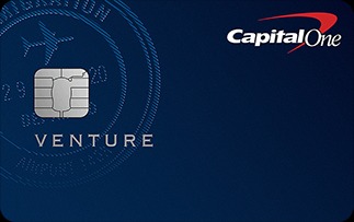 Capital One Venture Rewards credit card shown on a dark blue background, featuring a silver chip on the left, the word ‘Venture’ below it, a subtle airplane and travel-themed pattern in the background, and the Capital One logo in the top-right corner, conveying a premium travel rewards credit card design.